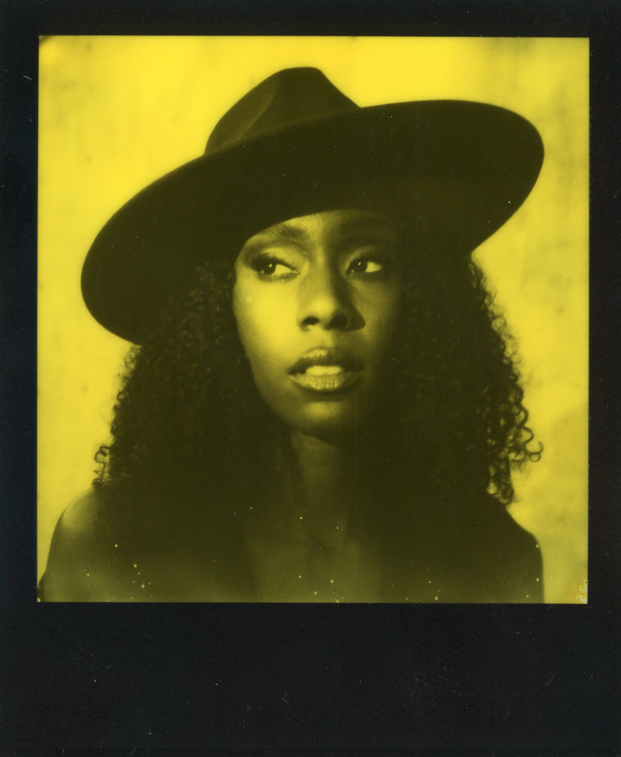 duochrome yellow polaroid film portrait of a beautiful black woman